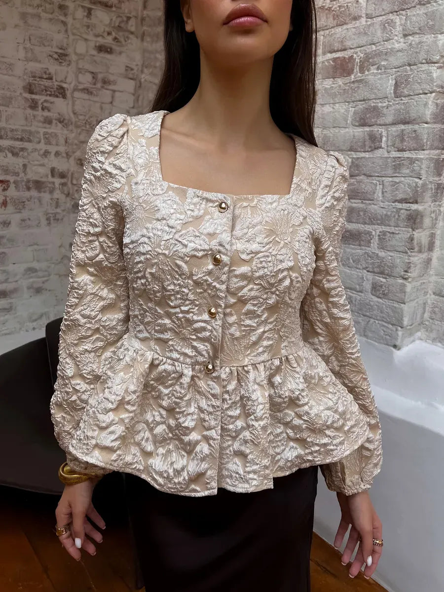 Floral jacquard fabric detail of the beige peplum blouse