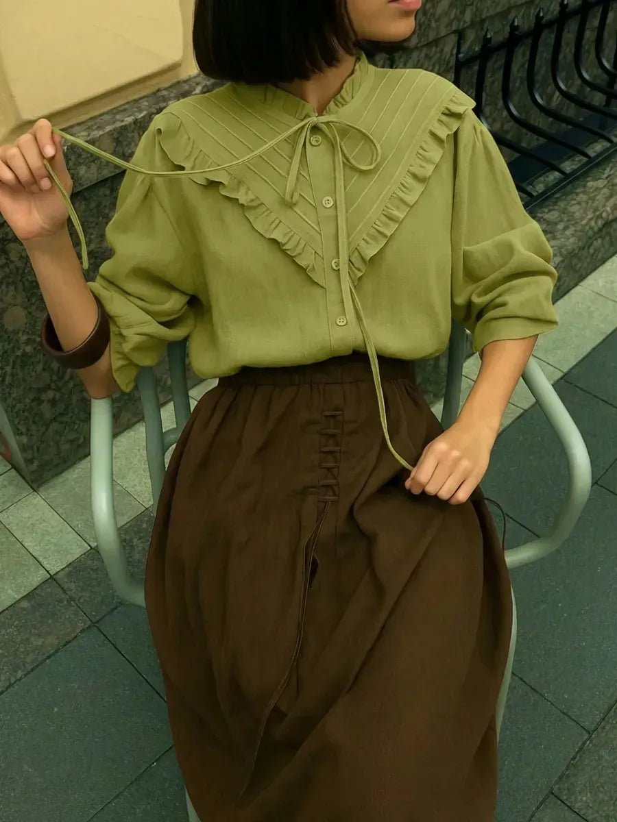 Lace-trimmed cuff detail on the olive green vintage blouse