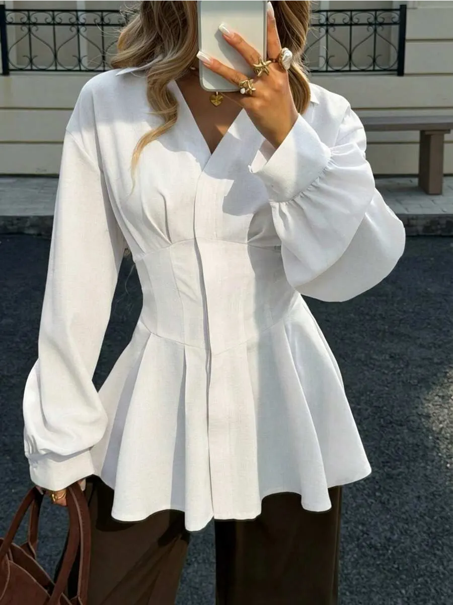 Corset-inspired waist detail on the white longline cotton shirt